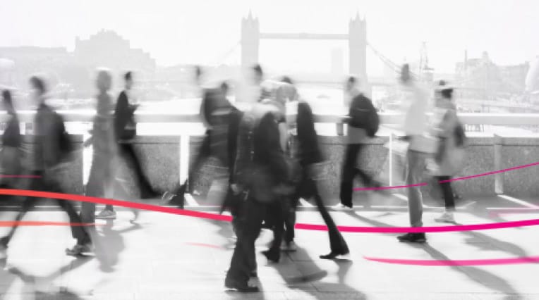 A busy pathway with blurred people walking past a bridge. Wavy gradient lines flow through them.