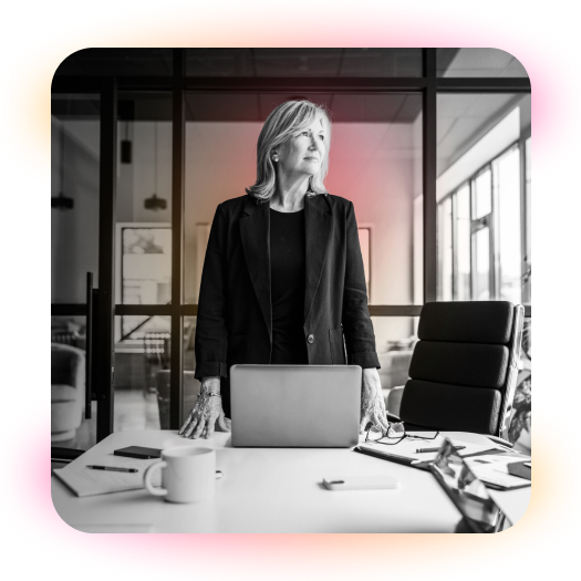 employee standing at her desk looking to the distance