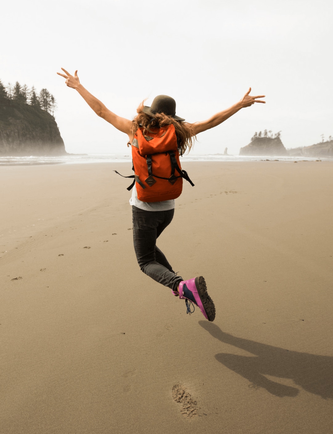 A Splunker skips on a beach, raising her hands to the sky. Splunk goes a step further to support employee wellbeing.