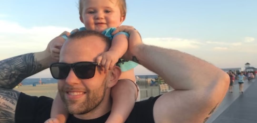 Brian Cusick, Senior Manager of Security Consulting Solution Engineering at Splunk with his child on his shoulders.