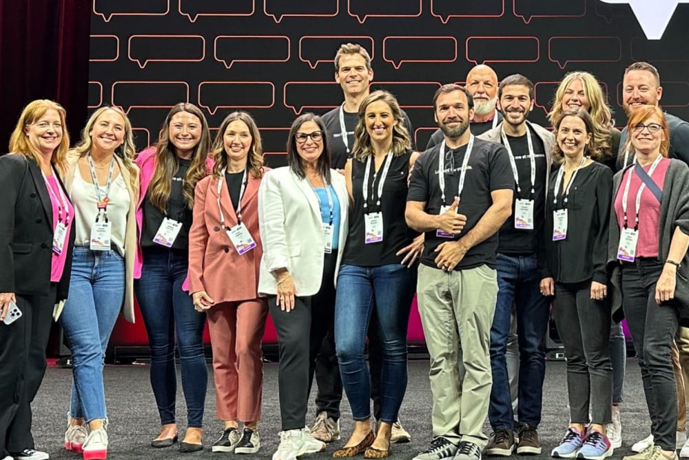 A large group of Splunkers wearing event badges standing together at a conference.