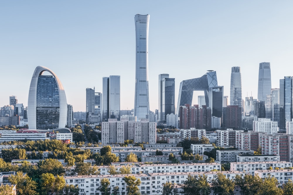 Sleek, futuristic chrome high rises stand behind smaller, shorter white buildings, creating the striking Beijing skyline. Splunk has offices here.