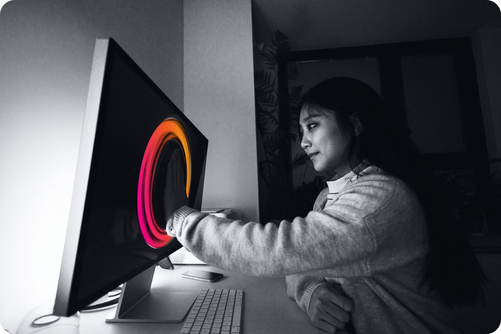 woman with hand on monitor