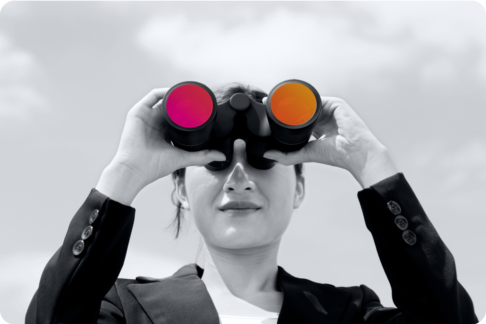 A woman wearing a business suit jacket looks through binoculars
