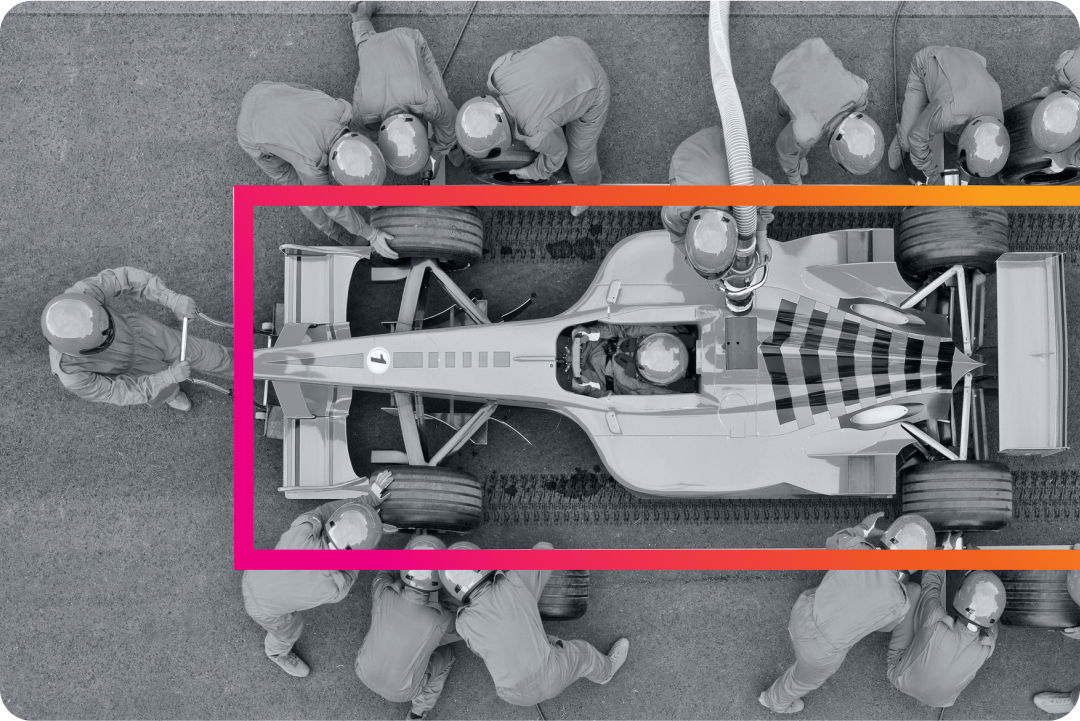 View from above of a pit crew working on a race car 