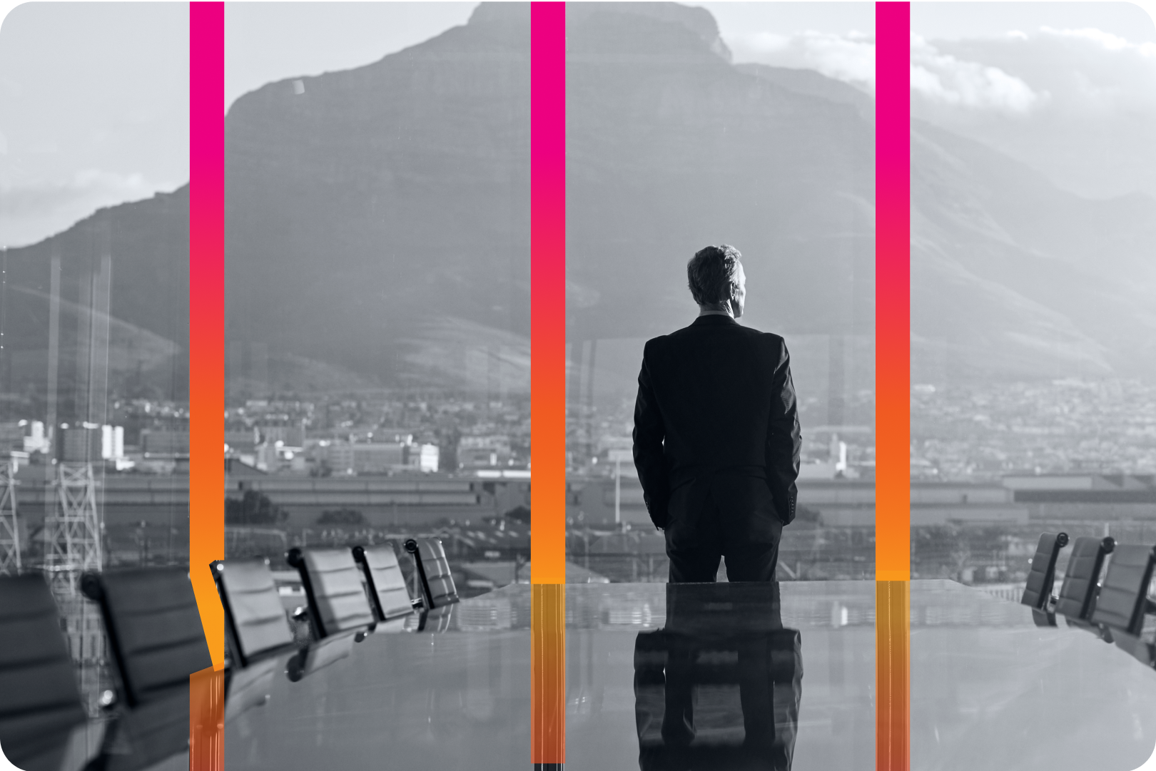 man in suit facing away from a corporate meeting table